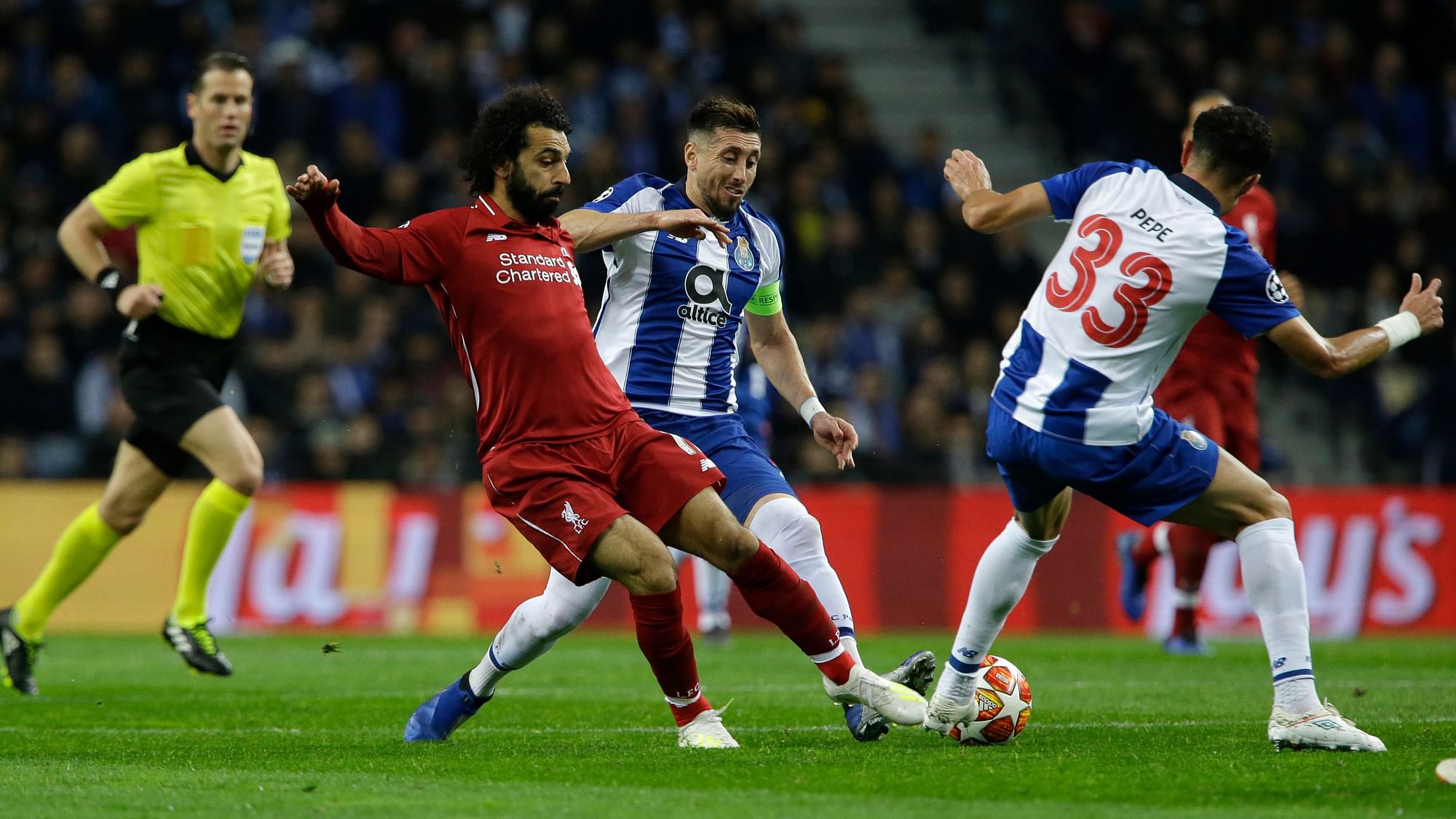 Liverpool’s Mohamed Salah, left, challenges for the ball with Porto defender Pepe, right, and Porto midfielder Hector Herrera during the Champions League quarterfinal, 2nd leg, soccer match between FC Porto and Liverpool at the Dragao stadium in Porto.