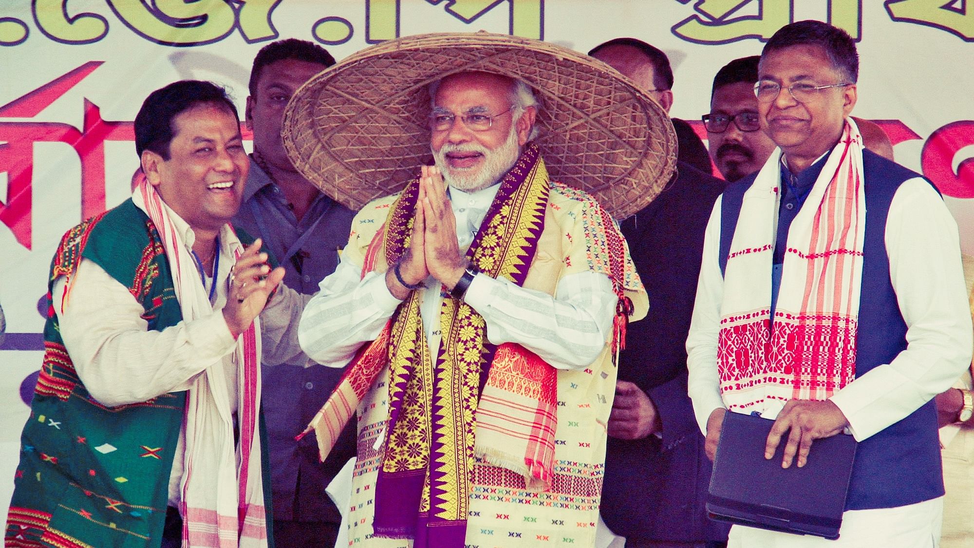 Narendra Modi, wearing a “Japi” (a traditional hat of Assam), receives a wooden Rhino by his supporters during a rally ahead of the 2014 general elections, at Guwahati.&nbsp;