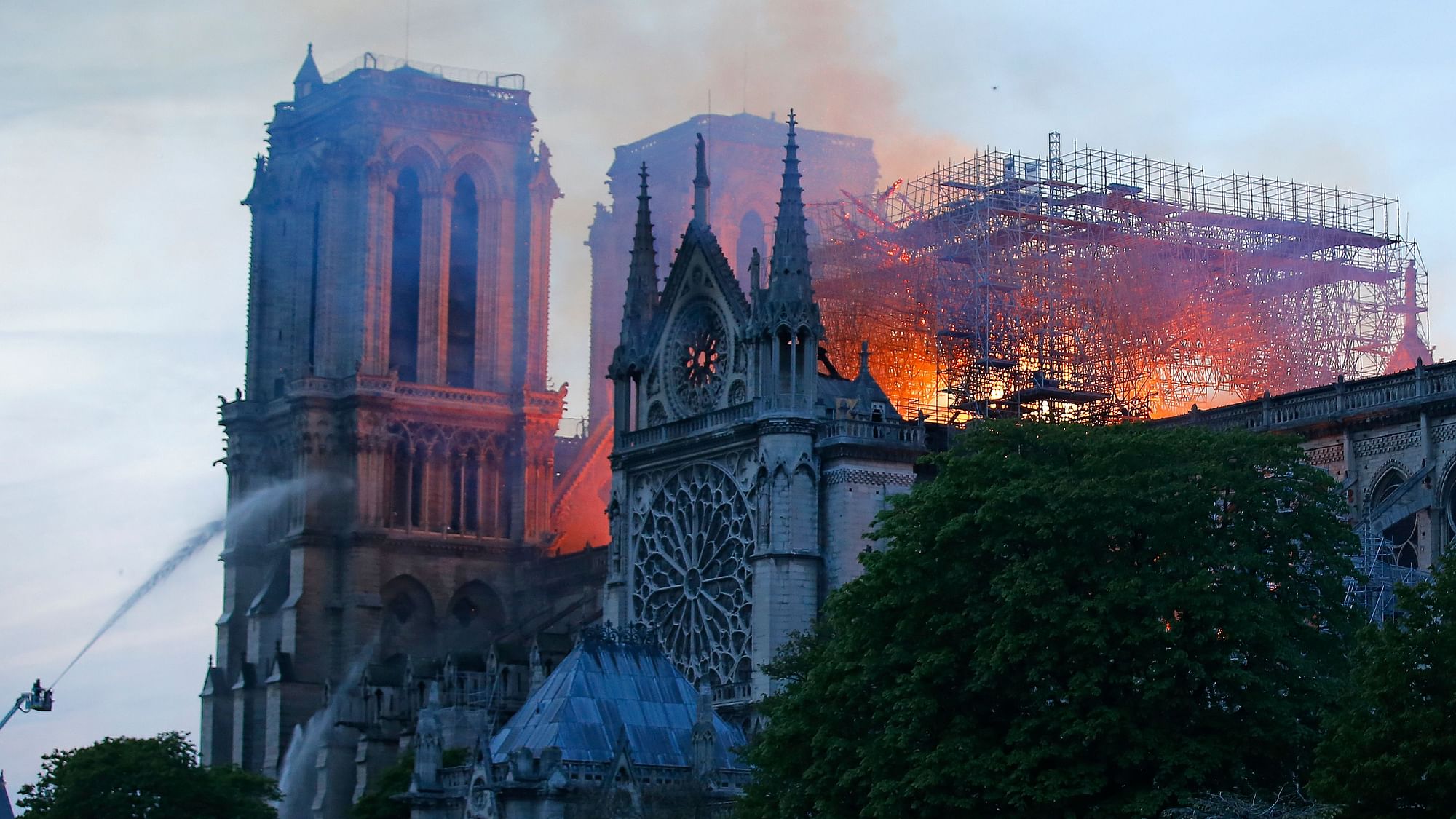 A colossal fire swept through the famed Notre-Dame Cathedral in central Paris on Monday, causing a spire to collapse and threatening to destroy the entire masterpiece and its precious artworks.