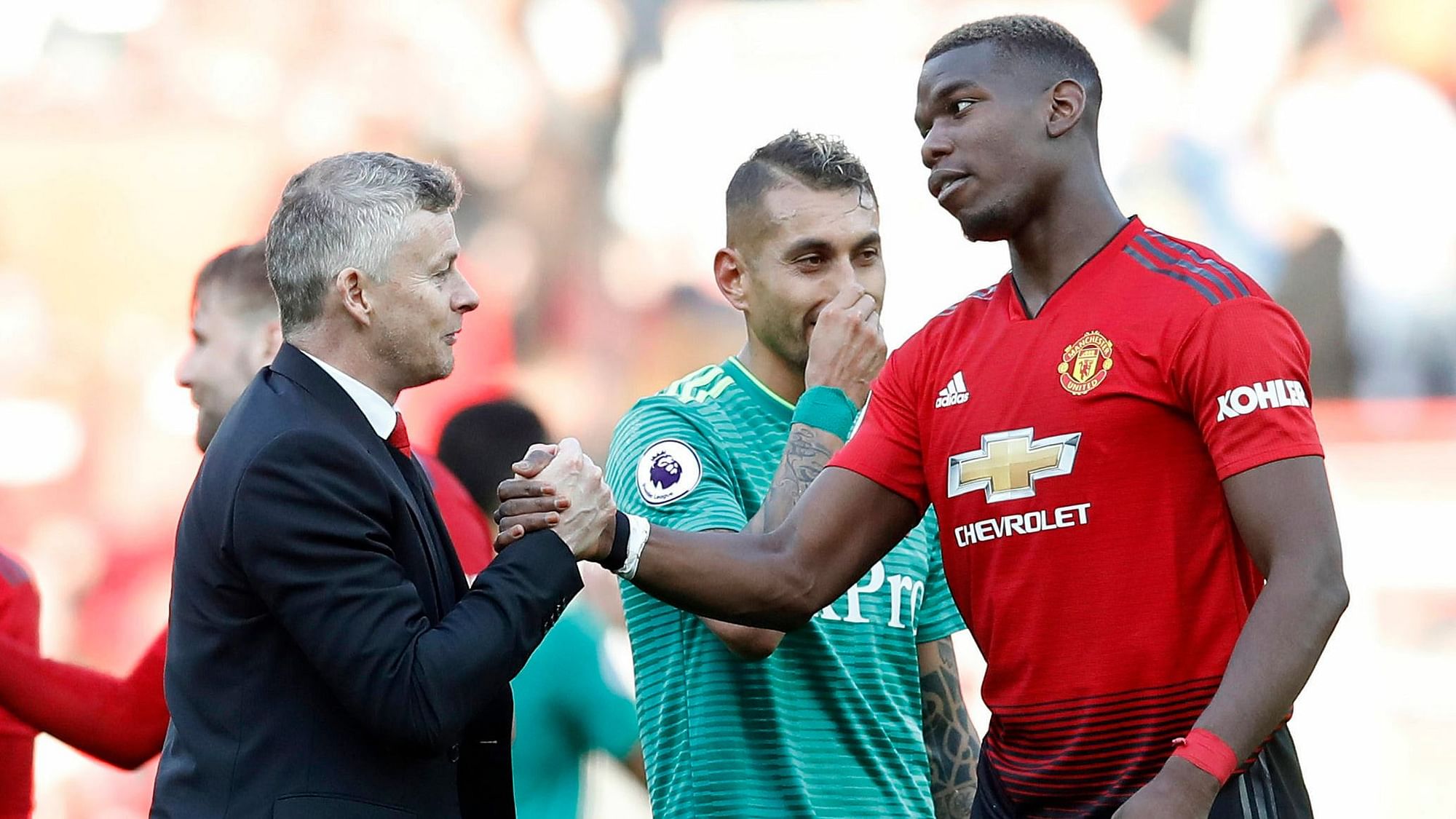 Manchester United manager Ole Gunnar Solskjaer with Paul Pogba after the final whistle during the English Premier League soccer match between Manchester United and Watford at Old Trafford Stadium, Manchester, England.