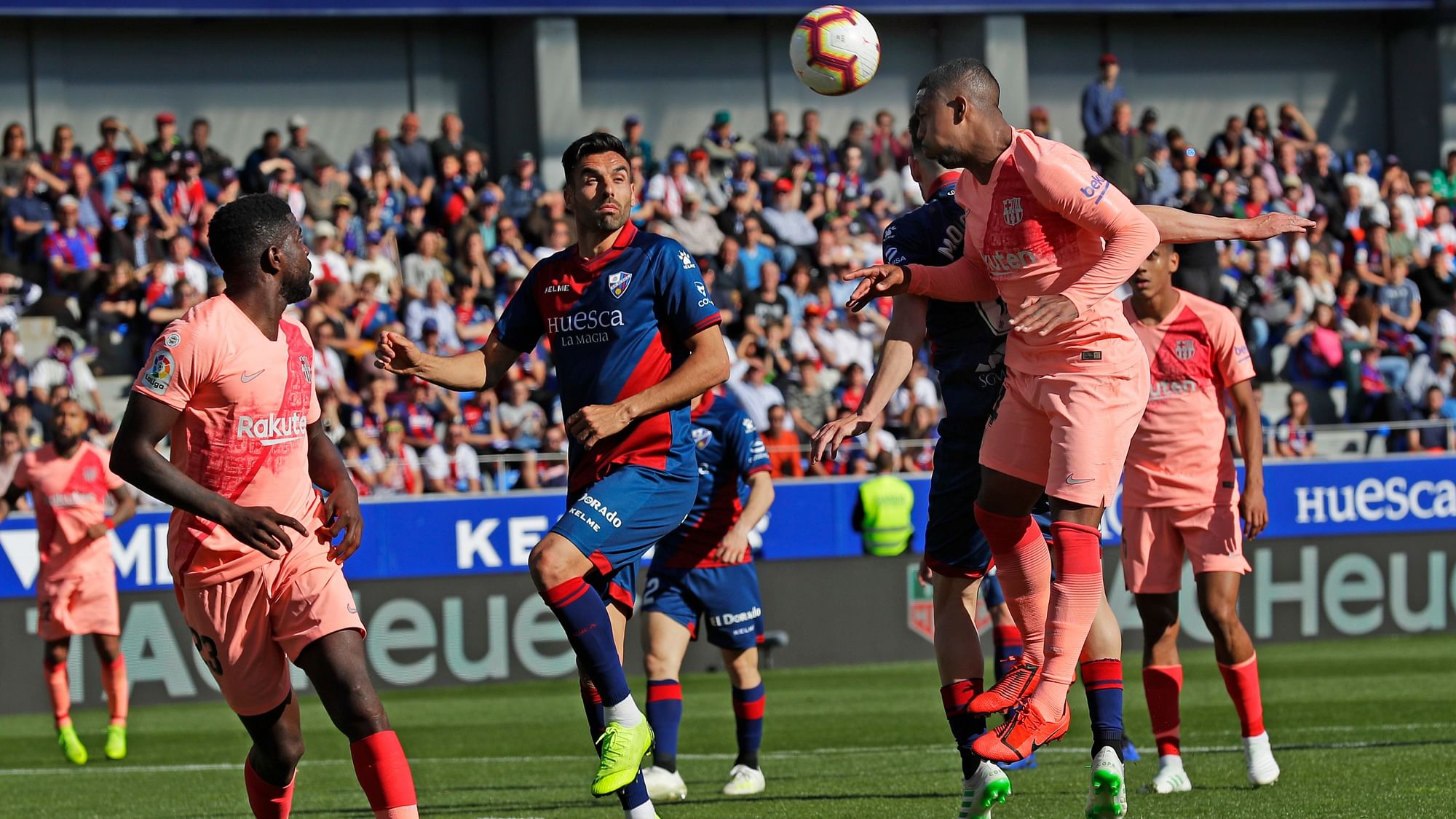 Barcelona’s Malcom Oliveira, right, heads the ball during the Spanish La Liga football match between Huesca and Barcelona at the Alcoraz stadium in Huesca.