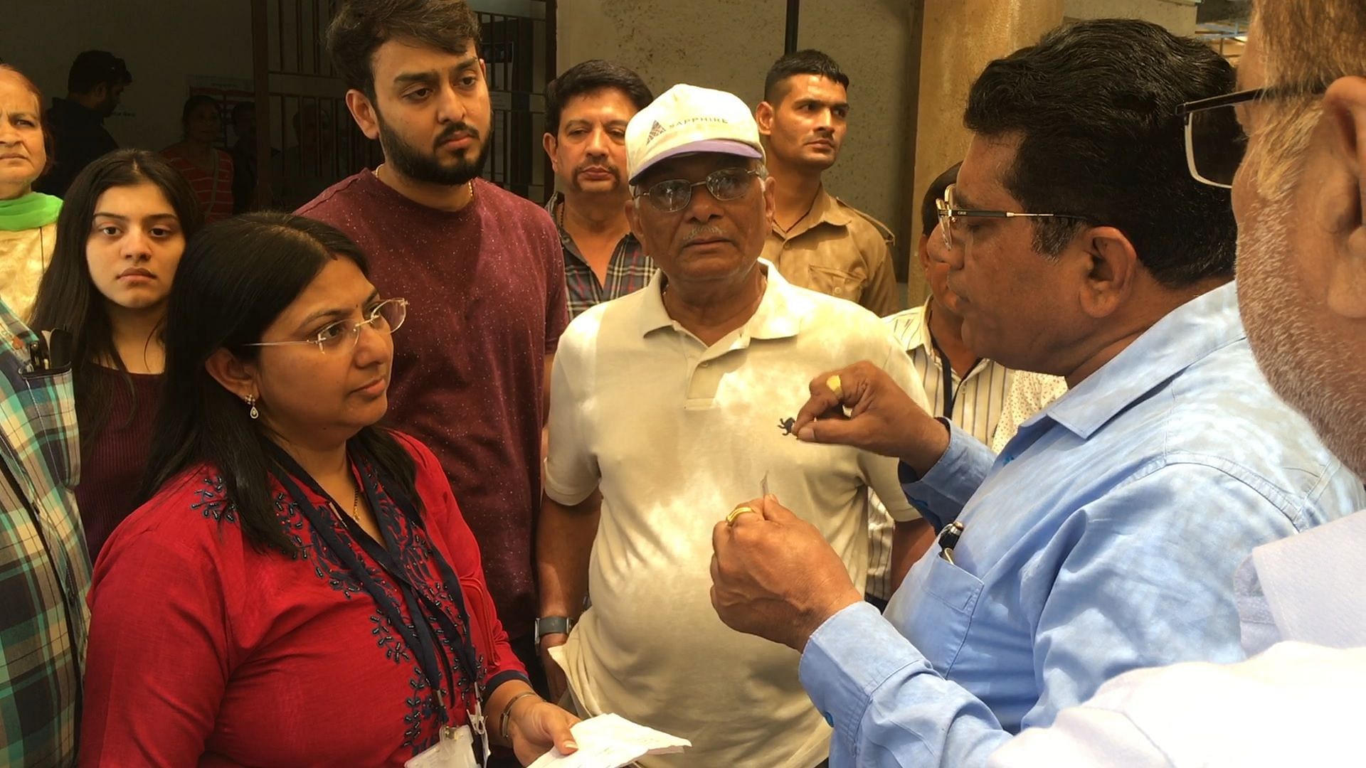 Voters argue with Deputy Collector of Ahmedabad Bharti Vaghela at Polling Booth number 165 and 166 in Bodakdev area of Ahmedabad on 23 April