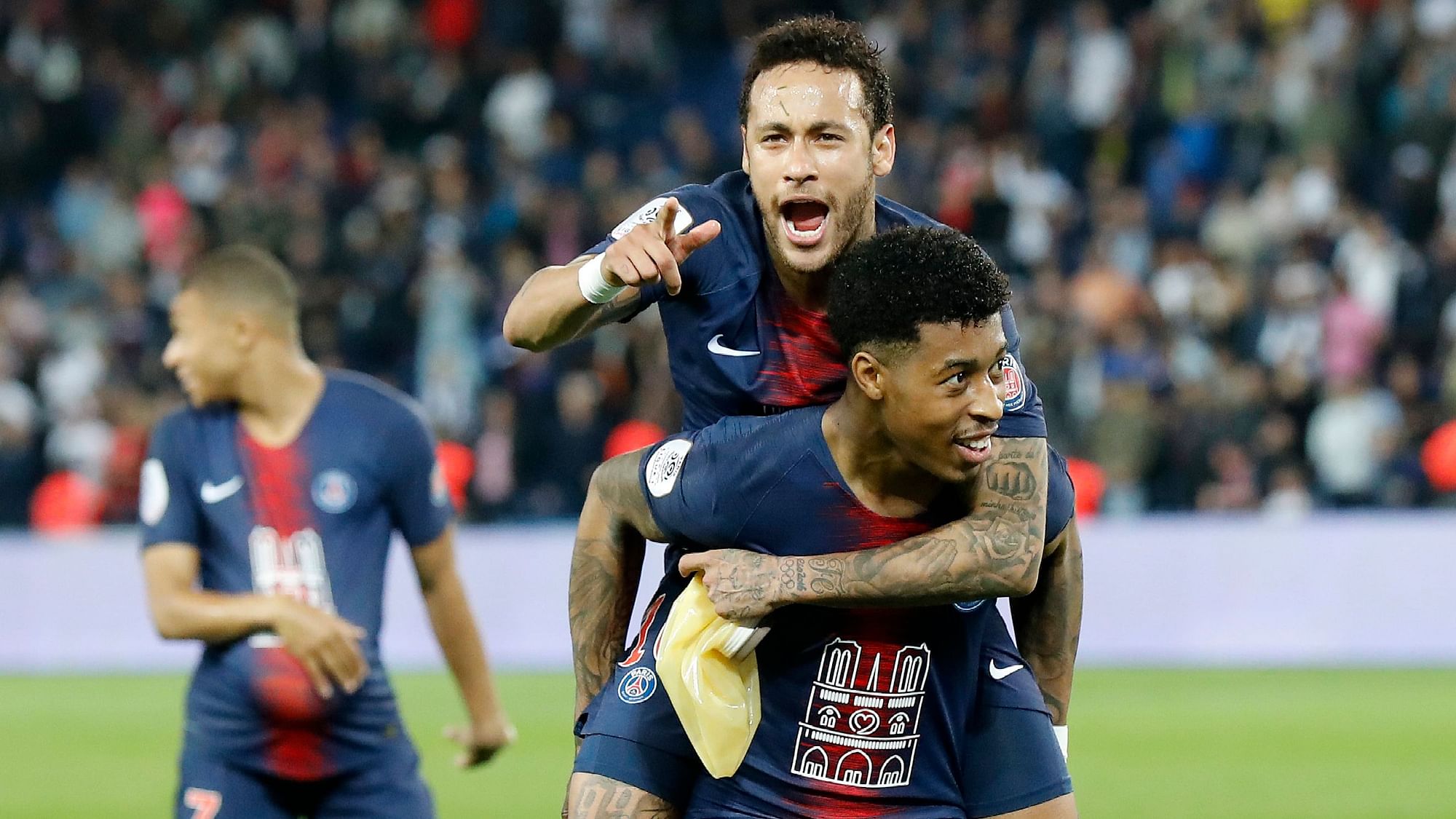 PSG’s Neymar, top, sits on the back of Presnel Kimpembe after the French League One football match between Paris-Saint-Germain and Monaco.