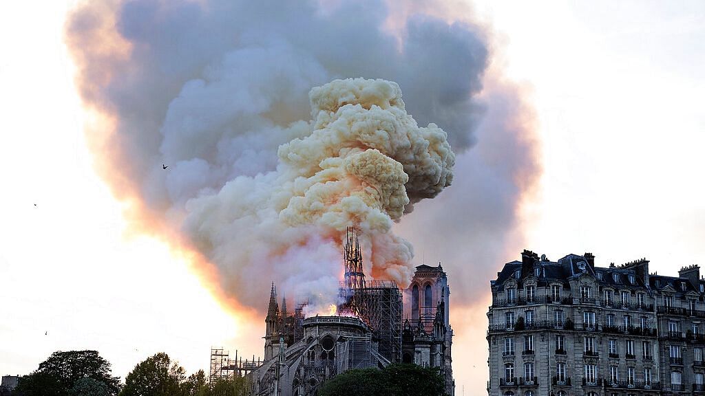 Flames and smoke rise as the spire on Notre-Dame cathedral collapses in Paris on Monday, 15 April.&nbsp;