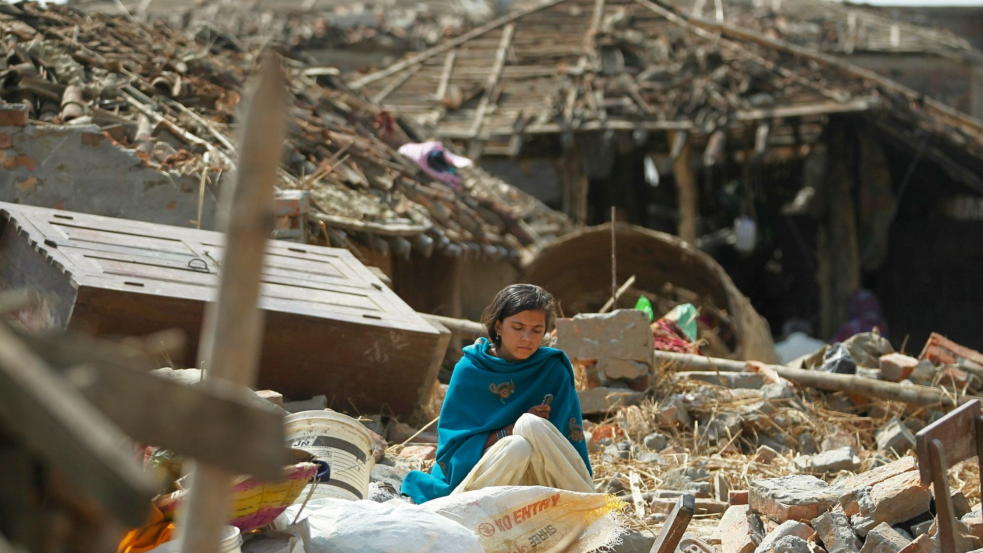 A woman sits in the middle of the debris of a residential house damaged in rainstorm in Bara district, 125 kilometers (75 miles) south of Kathmandu, Nepal, Monday, 1 April, 2019.&nbsp;