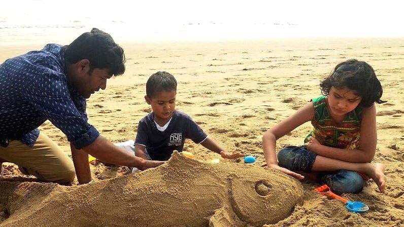 Sand artist Sudarsan Pattnaik with his children at Puri sea beach in Odisha.