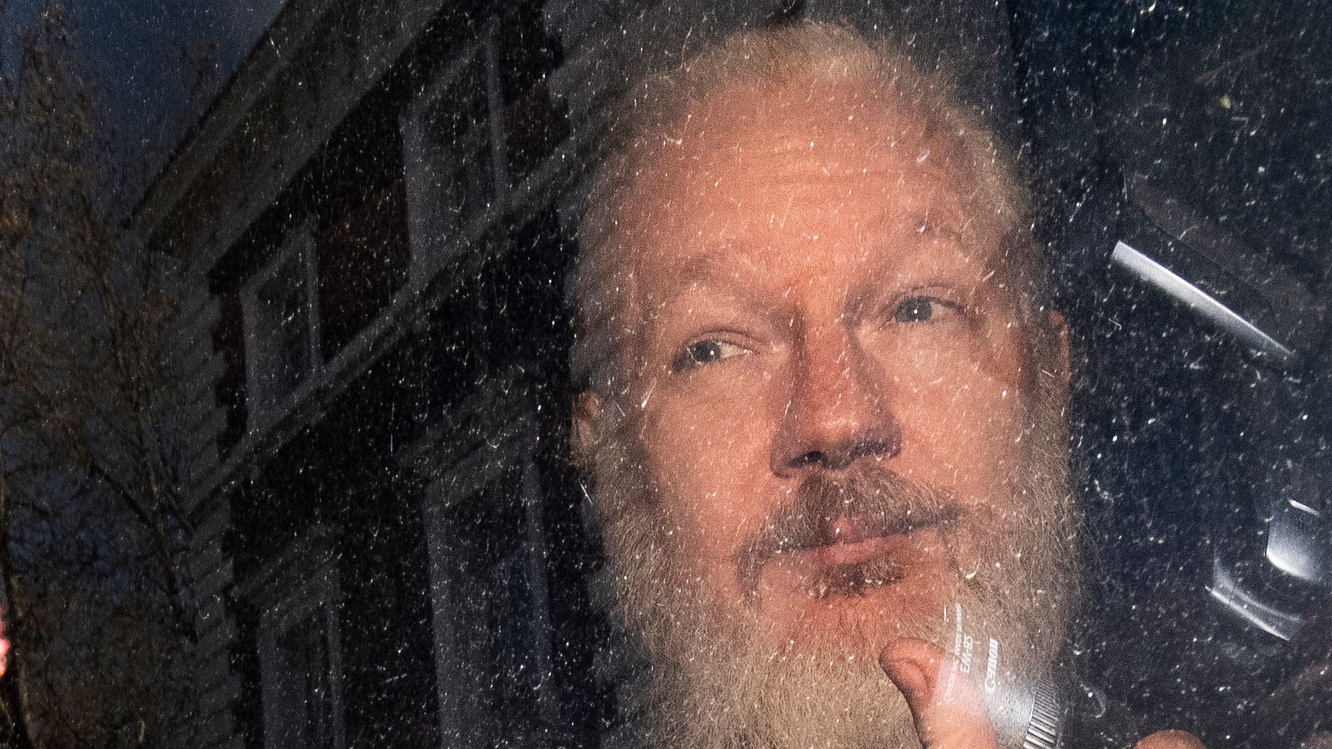 Julian Assange gestures as he arrives at Westminster Magistrates’ Court in London, after the WikiLeaks founder was arrested by officers from the Metropolitan Police and taken into custody Thursday 11 April 2019.&nbsp;