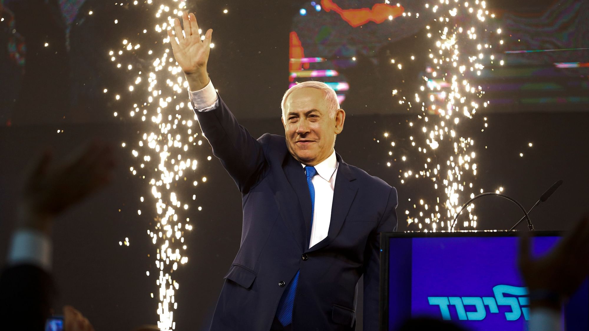 Israel’s Prime Minister Benjamin Netanyahu waves to his supporters after polls for general elections closed in Tel Aviv on 10 April.