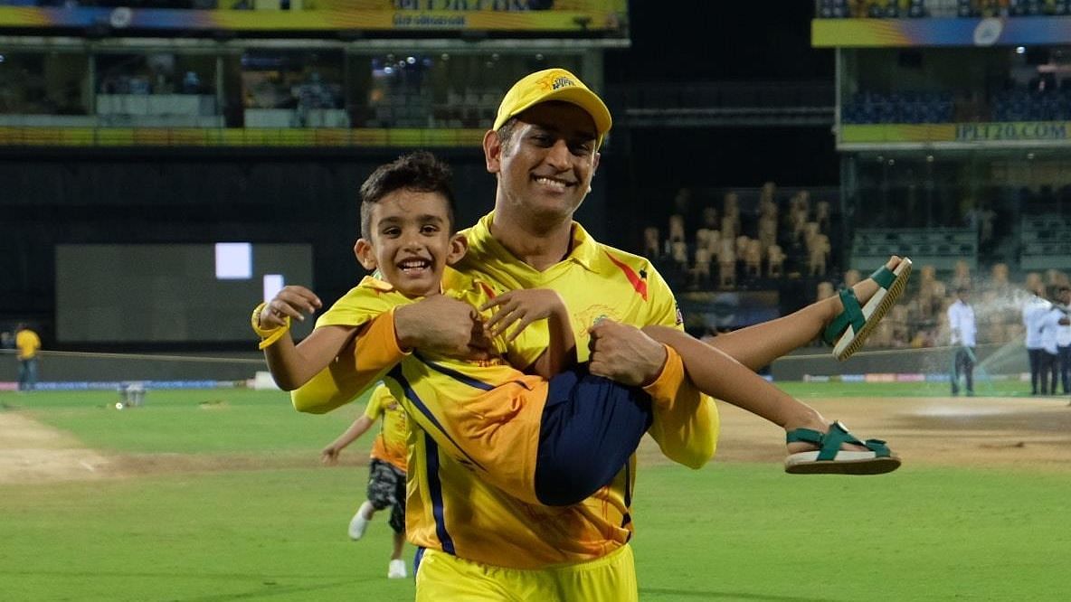 MS Dhoni carries Imran Tahir’s son after racing the kids following a win in Chennai on Friday.