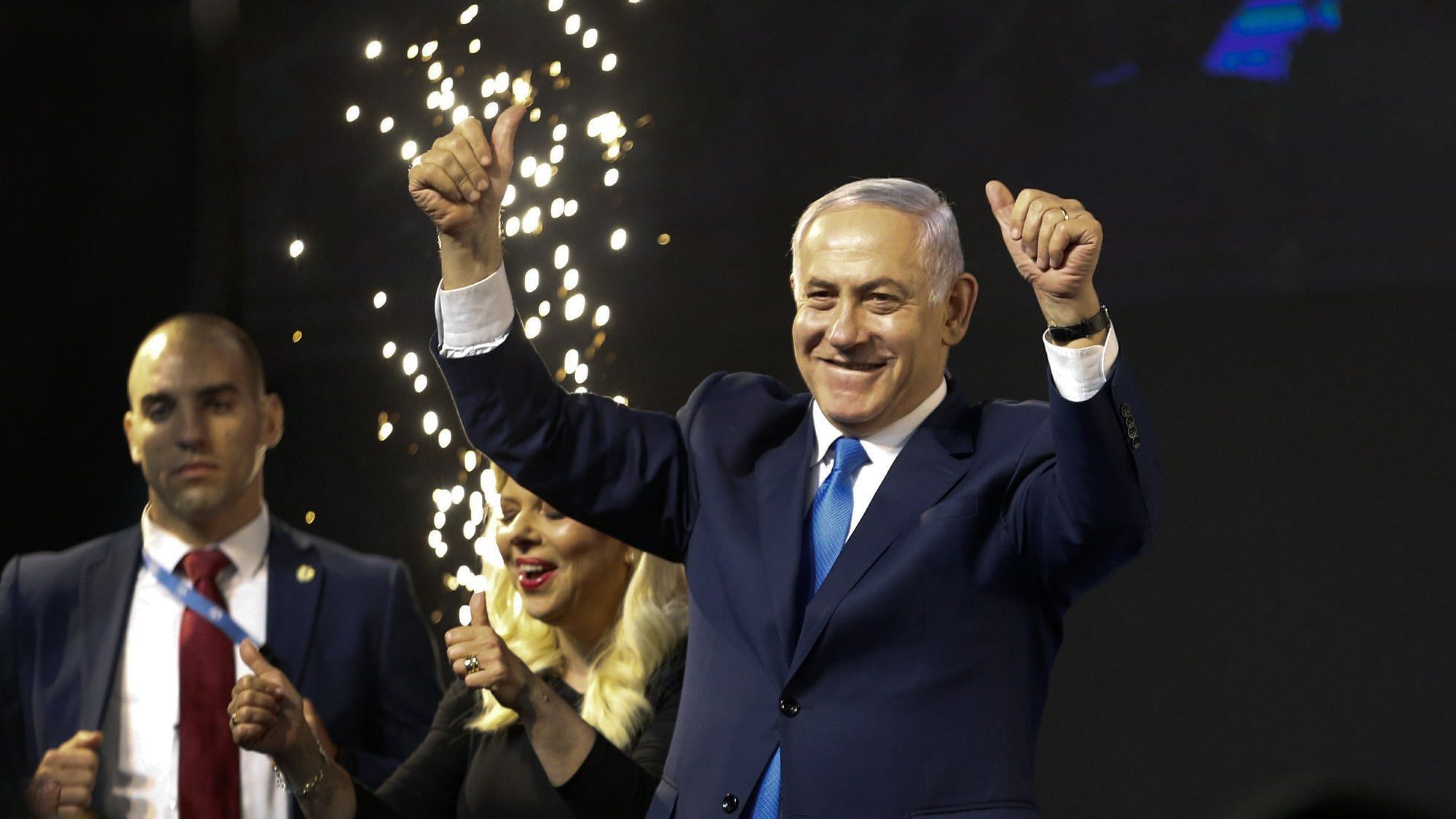 Israel’s Prime Minister Benjamin Netanyahu waves to his supporters after polls for Israel’s general elections closed in Tel Aviv.