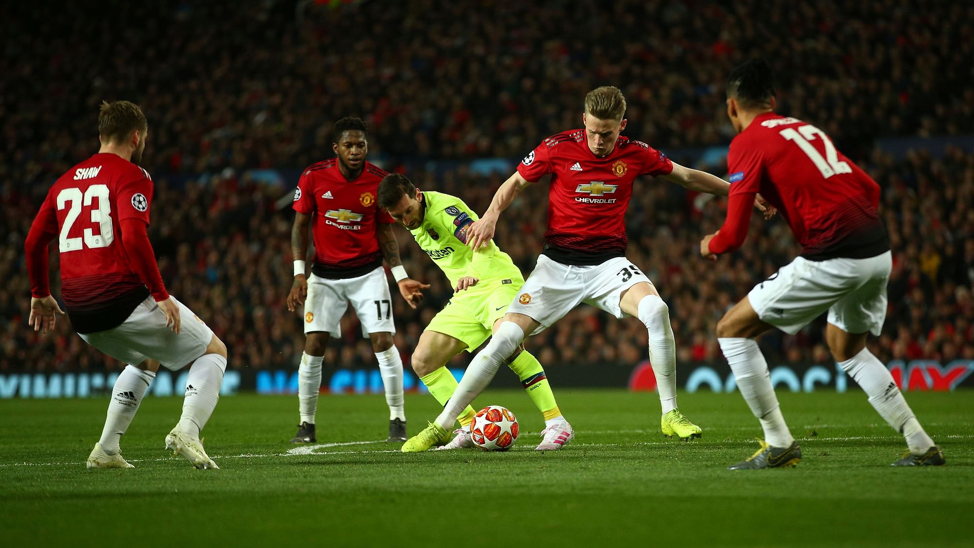 Barcelona’s Lionel Messi, center, vies for the ball with Manchester United’s Scott McTominay.