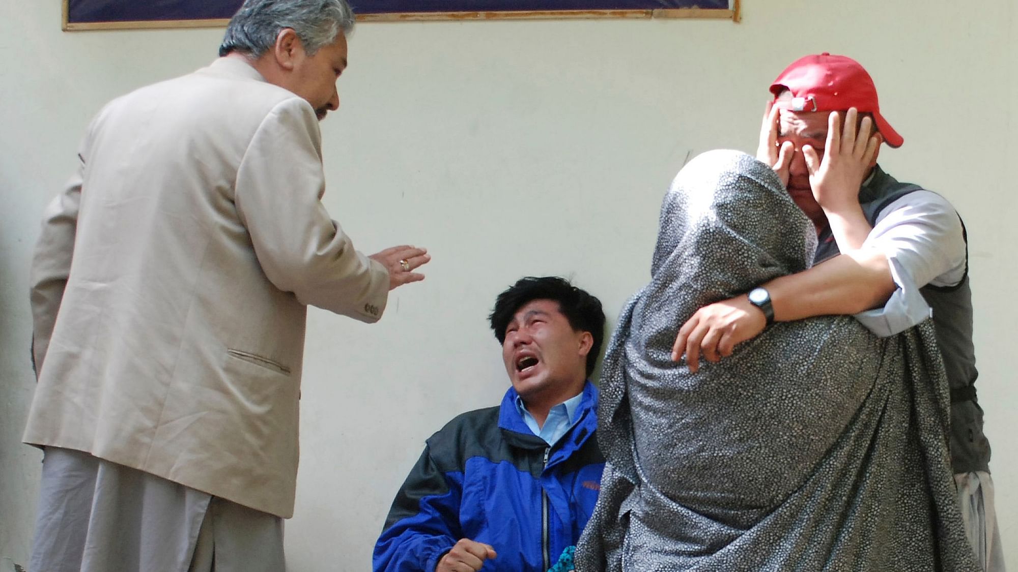 Family members of the blast victims comfort each other outside a mortuary in Quetta, Pakistan, Friday, 12 April 2019.&nbsp;