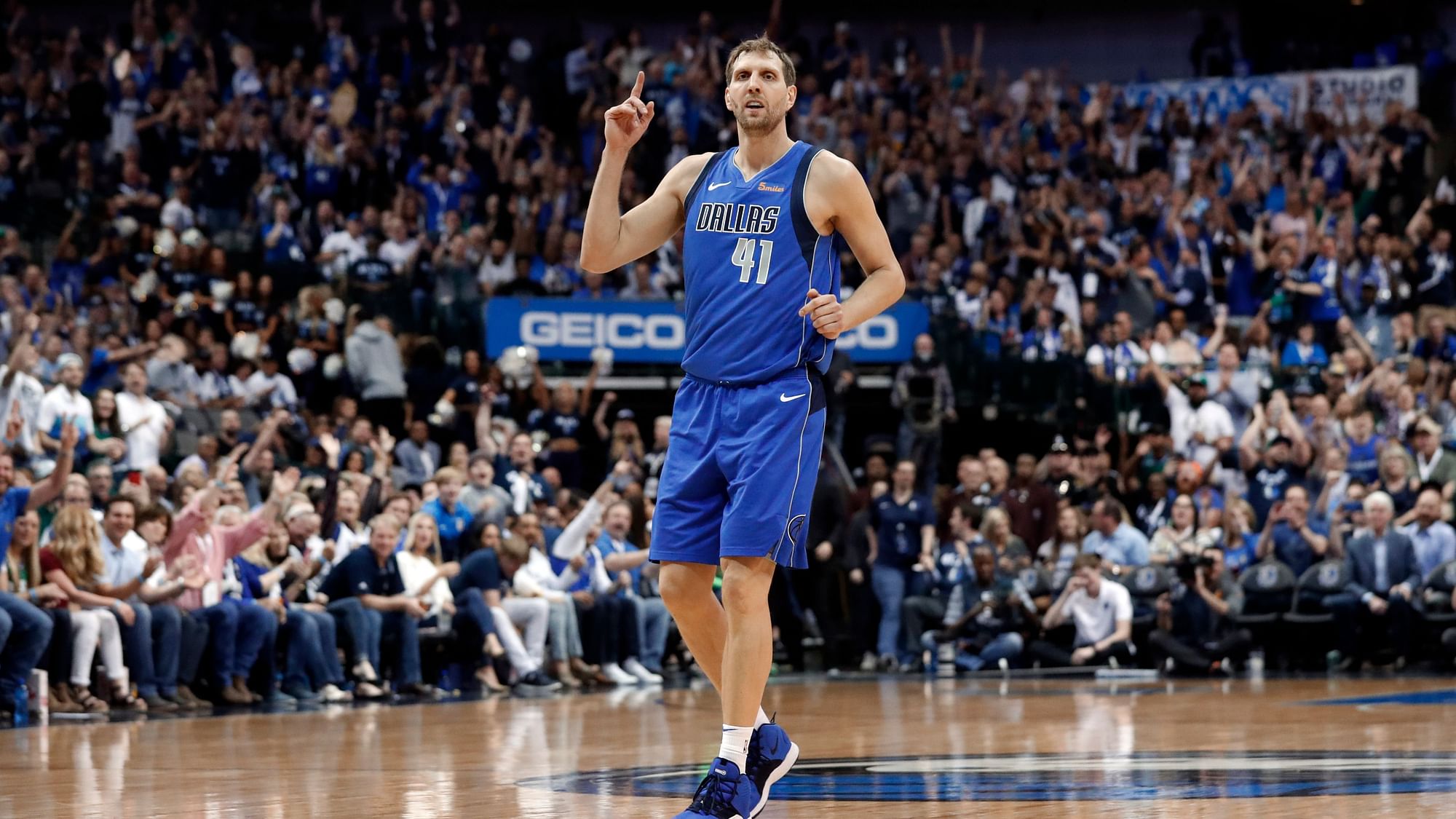 Dallas Mavericks’ Dirk Nowitzki (41) celebrates sinking a 3-point basket during the second half of the team’s NBA basketball game against the Phoenix Suns in Dallas.