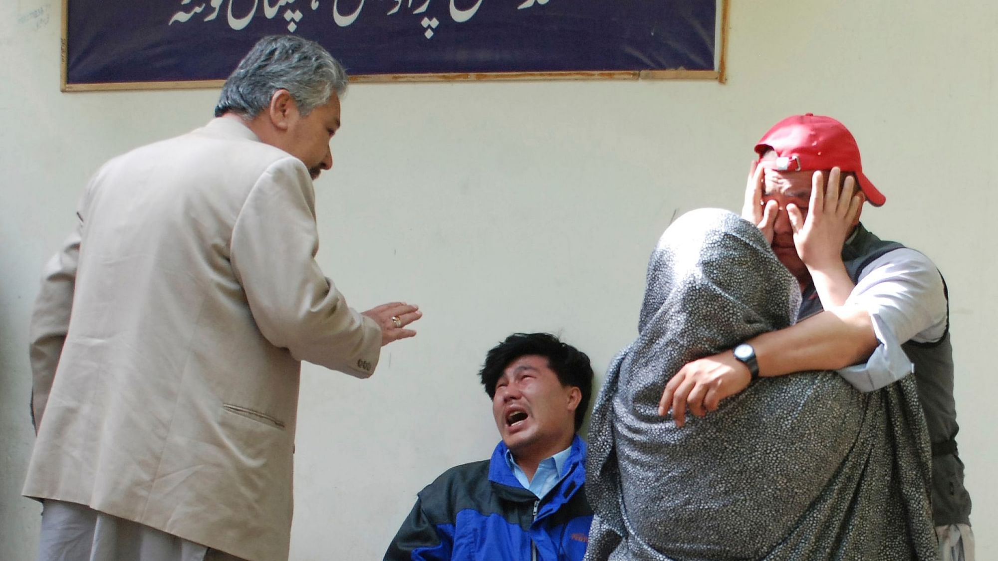 Family members of the blast victims comfort each other outside a mortuary in Pakistan’s Quetta on 12 April 2019.