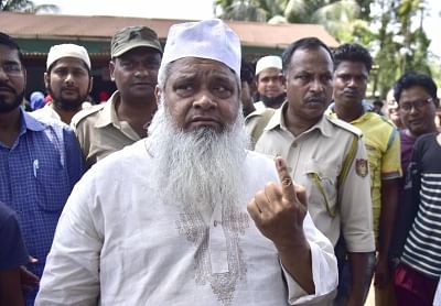Hojai: All India United Democratic Front (AIUDF) chief Maulana Badruddin Ajmal shows his forefinger marked with indelible ink after casting vote during the second phase of Lok Sabha polls, in Assam