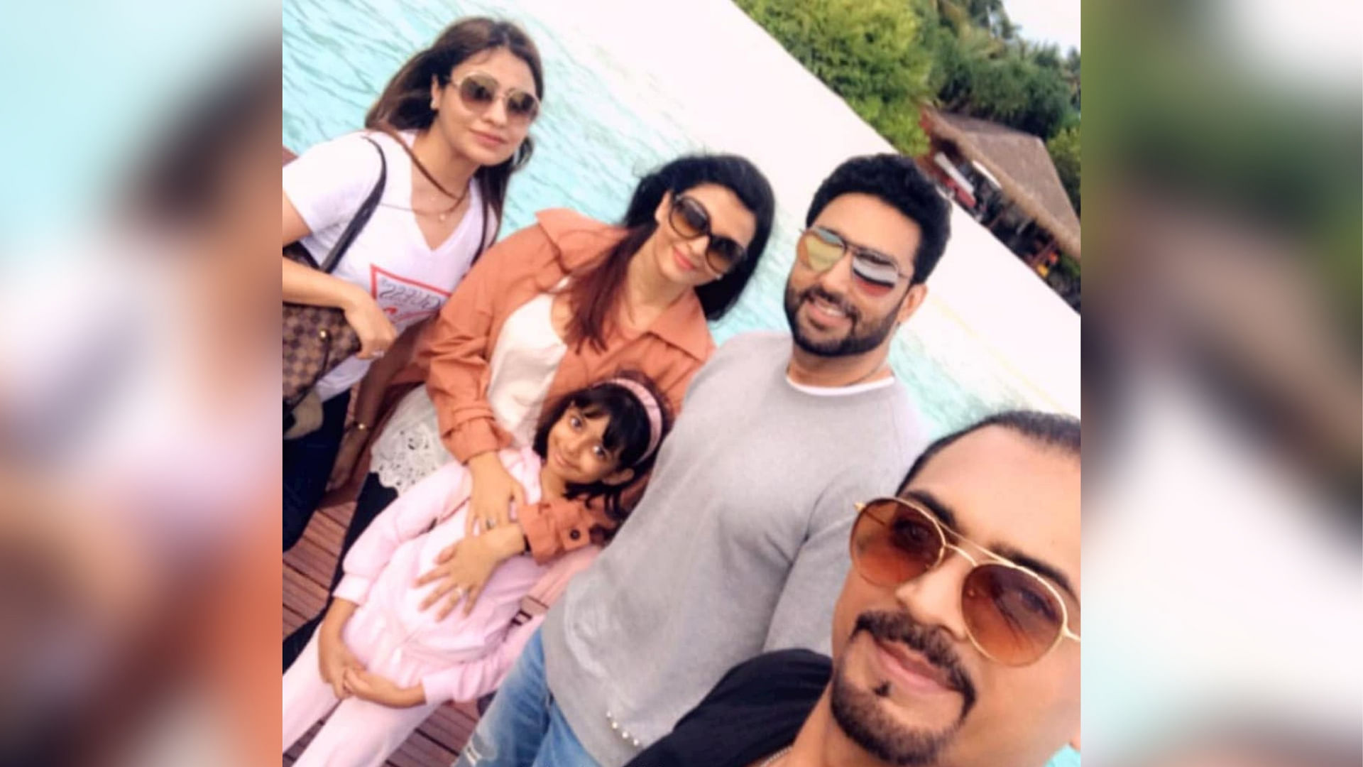 Abhishek Bachchan, Aishwarya Rai and their daughter Aaradhya pose with fans in Maldives.