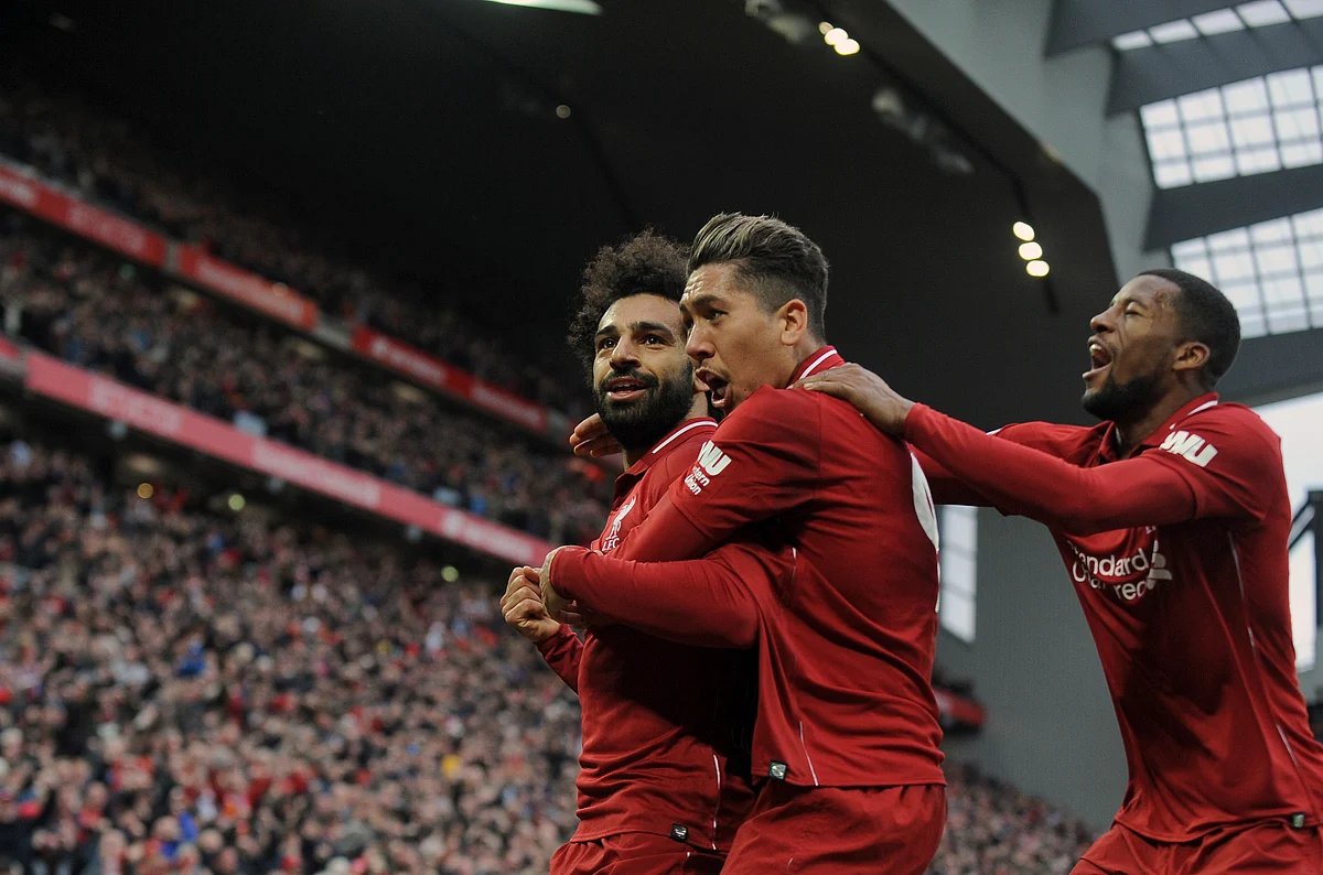 Liverpool’s Mohamed Salah, left, Roberto Firmino, center, and Georginio Wijnaldum celebrate after Tottenham’s Toby Alderweireld scores an own goal past his goalkeeper.