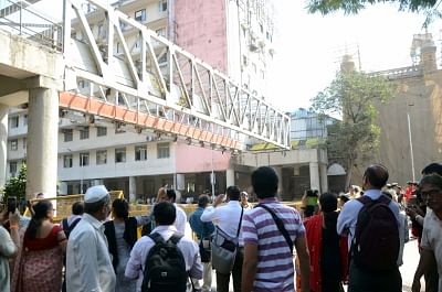 Mumbai: Locals gather at the site where a portion of a pedestrian bridge crashed near the Chhatrapati Shivaji Maharaj Terminus , in Mumbai on March 15, 2019. (Photo: IANS)