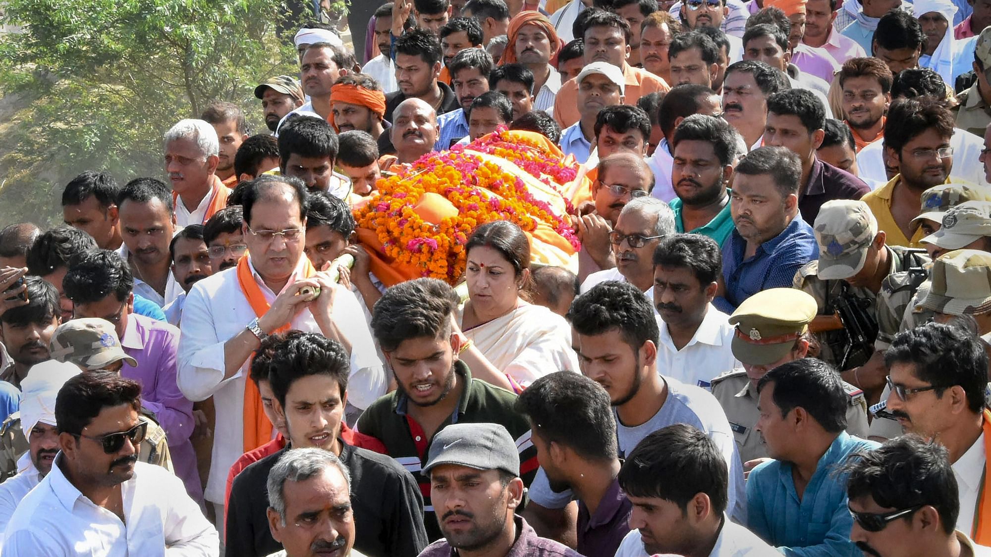 BJP MP Smriti Irani shoulders to the mortal remains of former village head (pradhan) Surendra Singh, during his funeral at his village in Amethi.