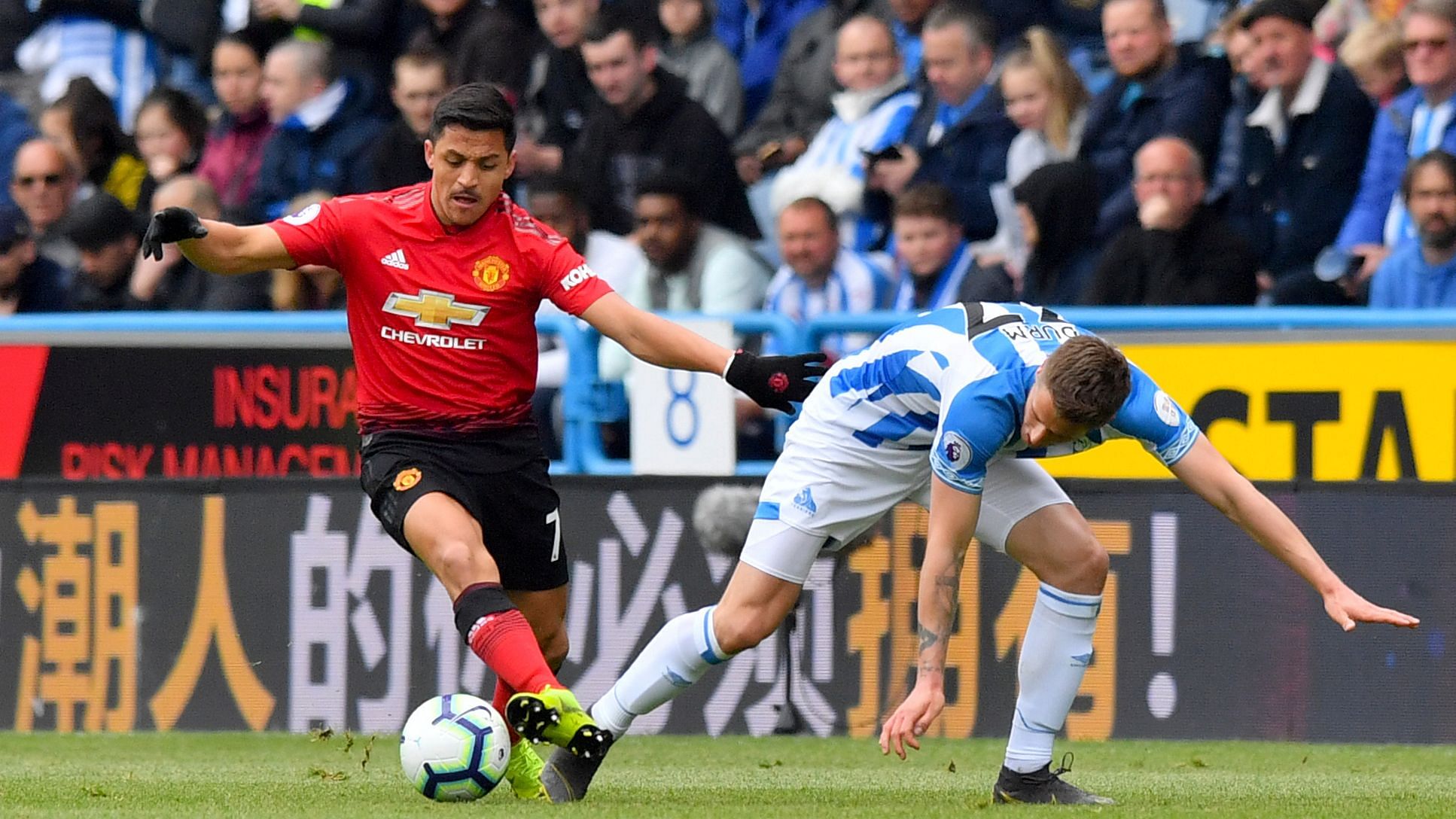 Manchester United’s Alexis Sanchez (left) and Huddersfield Town’s Erik Durm battle for the ball during the English Premier League match at the John Smith’s Stadium