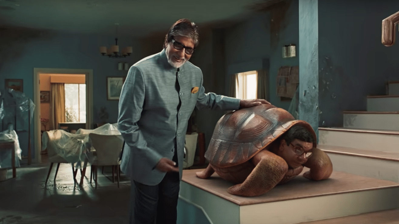 A still from the Ad campaign featuring Amitabh Bachchan with a Giant Turtle