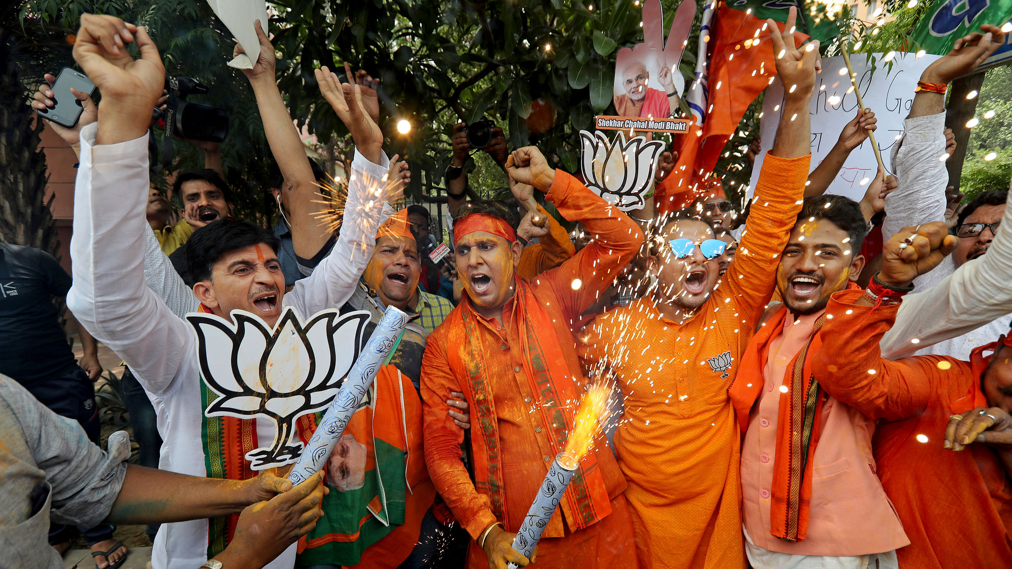Bharatiya Janata Party (BJP) workers celebrate outside BJP headquarters in New Delhi.