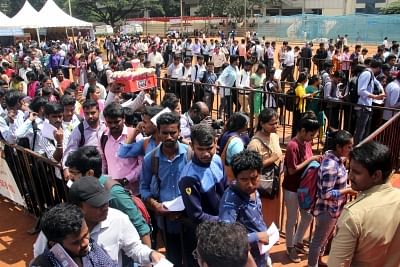 Job aspirants wait in queues for registration at a job fair. (Photo: IANS)