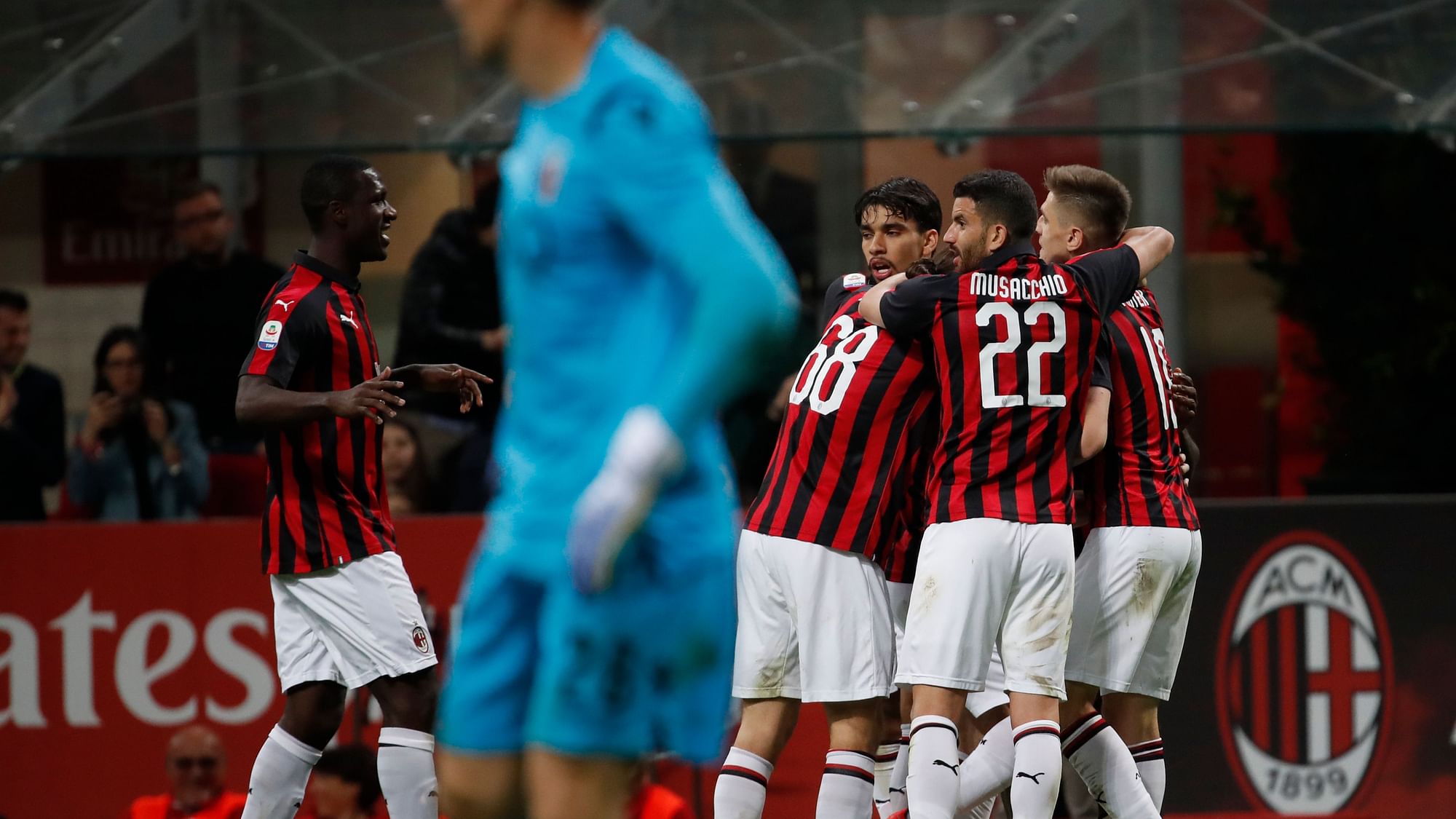 AC Milan’s Fabio Borini, right, celebrates with teammates after scoring past Bologna goalkeeper Lukasz Skorupski