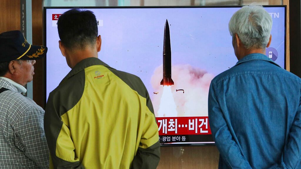 People watch a TV showing a file photo of North Korea’s weapon systems during a news program at the Seoul Railway Station on Thursday, 9 May.&nbsp;