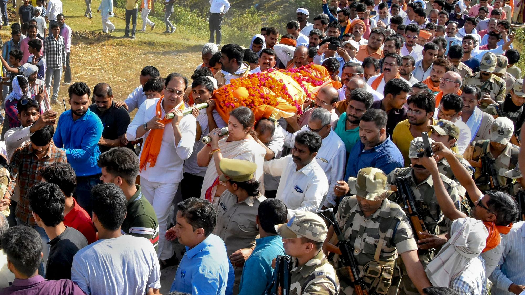 BJP MP Smriti Irani shoulders to the mortal remains of former village head (pradhan) Surendra Singh, during his funeral.