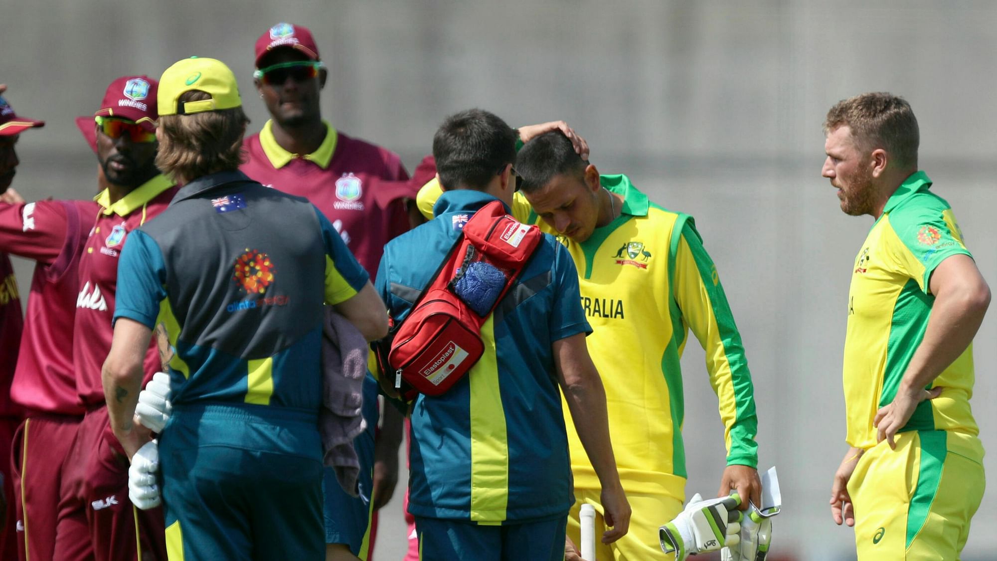 Australia’s Usman Khawaja (2nd right) rubs his head after being hit by a bouncer by West Indies’ Andre Russell during the World Cup warm-up match at the Nursery Ground, Southampton, England, Wednesday May 22, 2019.&nbsp;