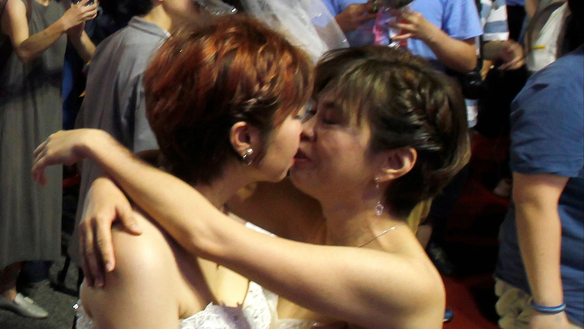 A gay couple kisses after tying the knot