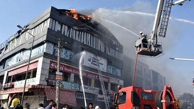 Surat: Fire fighting operations underway after a massive fire broke out at a coaching centre atop a four-storey building, in Sarthana area of Gujarat