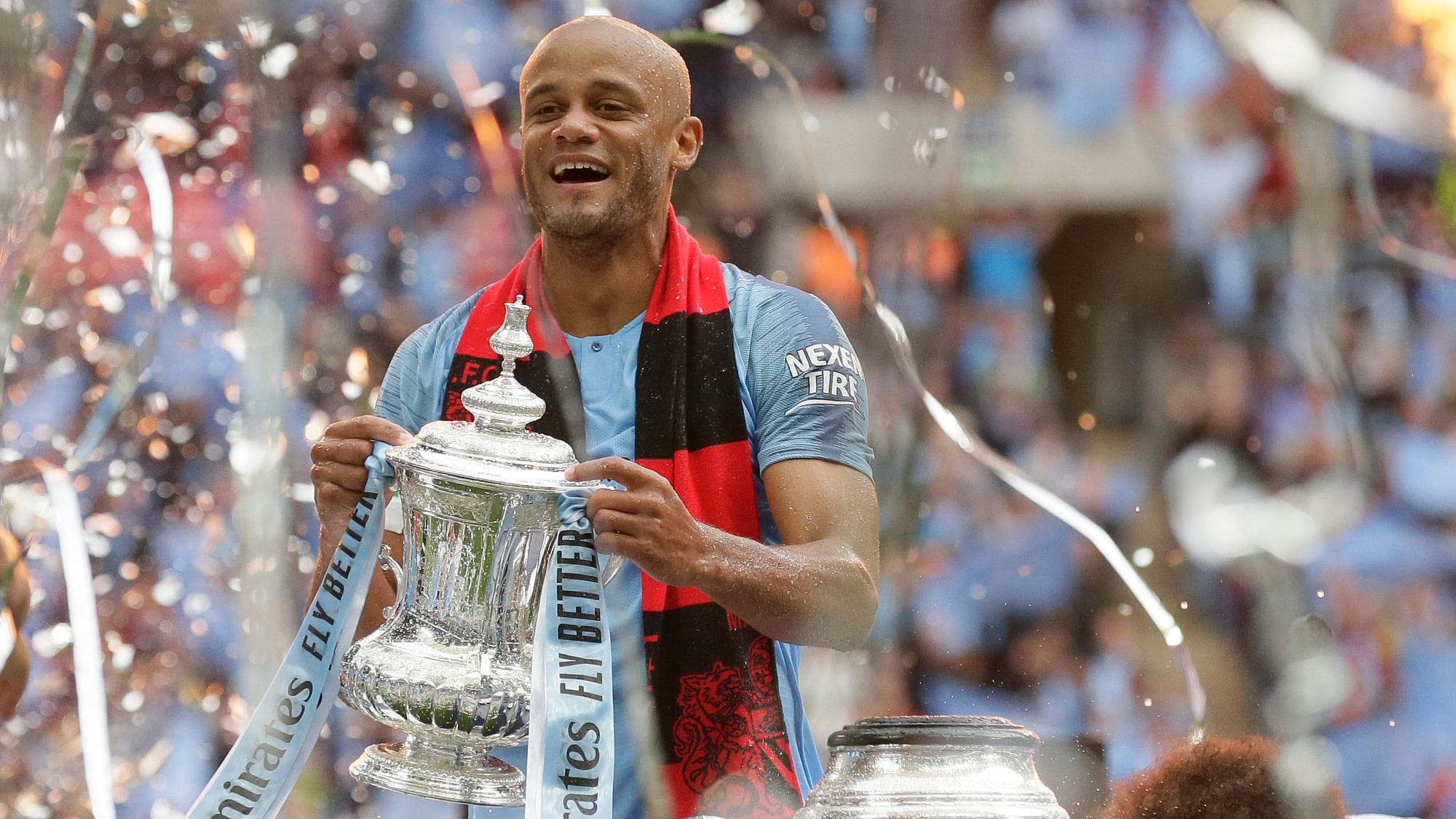 Manchester City’s team captain Vincent Kompany lifts the trophy after winning the English FA Cup Final soccer match between Manchester City and Watford at Wembley stadium in London, Saturday, 18 May 2019.