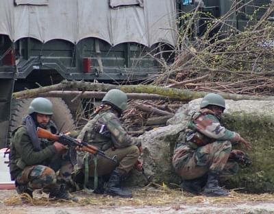 Kupwara: Security personnel take position during a gunfight with militants in Yaroo village of Jammu and Kashmir