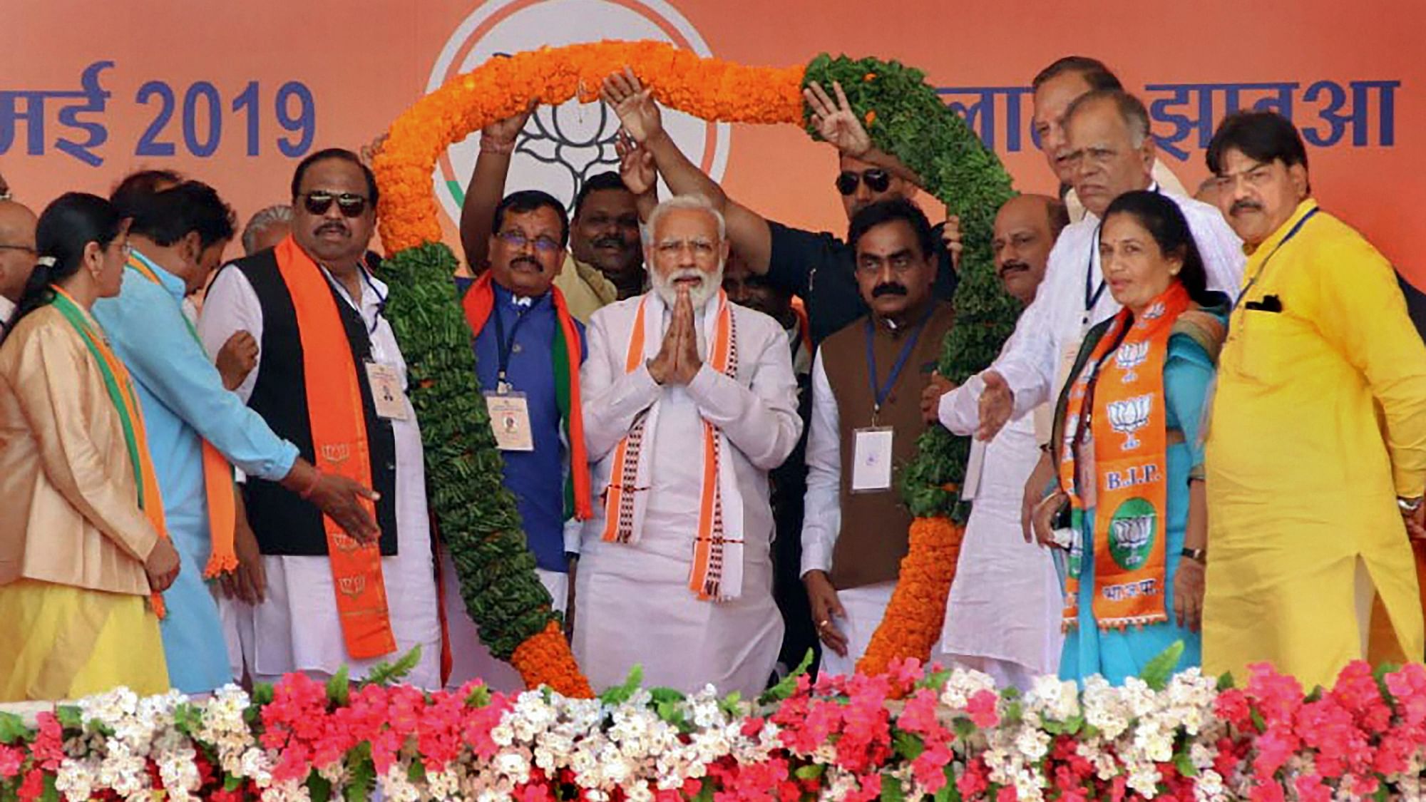 PM Modi being garlanded during an election campaign rally in Ratlam on 13 May 2019.