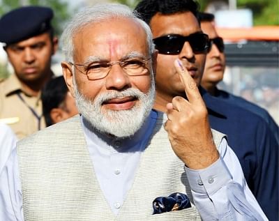 Ahmedabad : Prime Minister Narendra Modi  shows his forefinger marked with indelible ink after casting vote during the third phase of Lok Sabha polls, in Ahmedabad, Gujarat on April 23, 2019. (Photo: IANS)