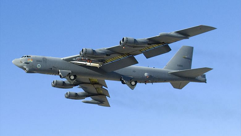 A new-generation weapon, in white, launches from an older one, the B-52 bomber. 