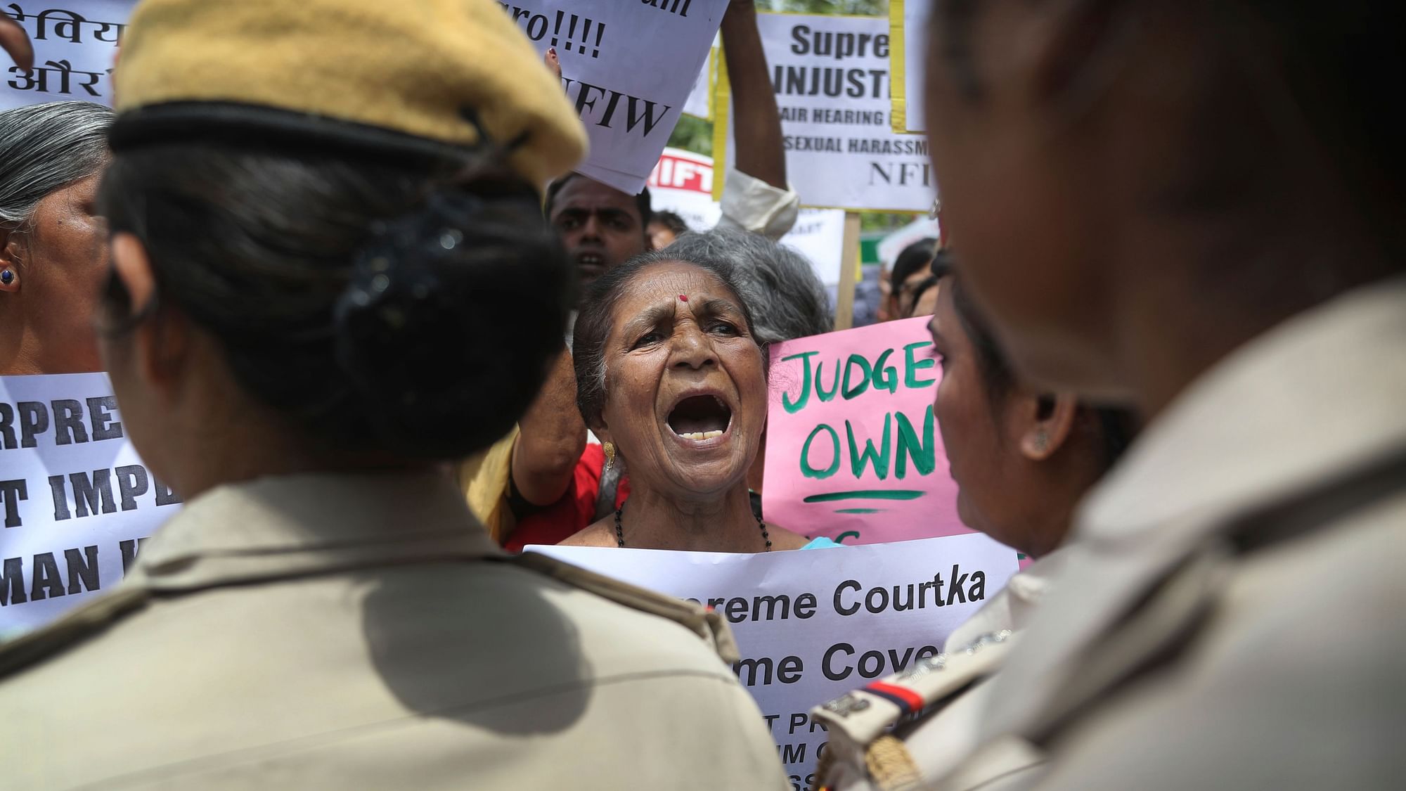 Indian women activists shout slogans during a protest against a court inquiry that cleared India’s Chief Justice of sexual harassment allegations made by a former employee at his official residence, in New Delhi.