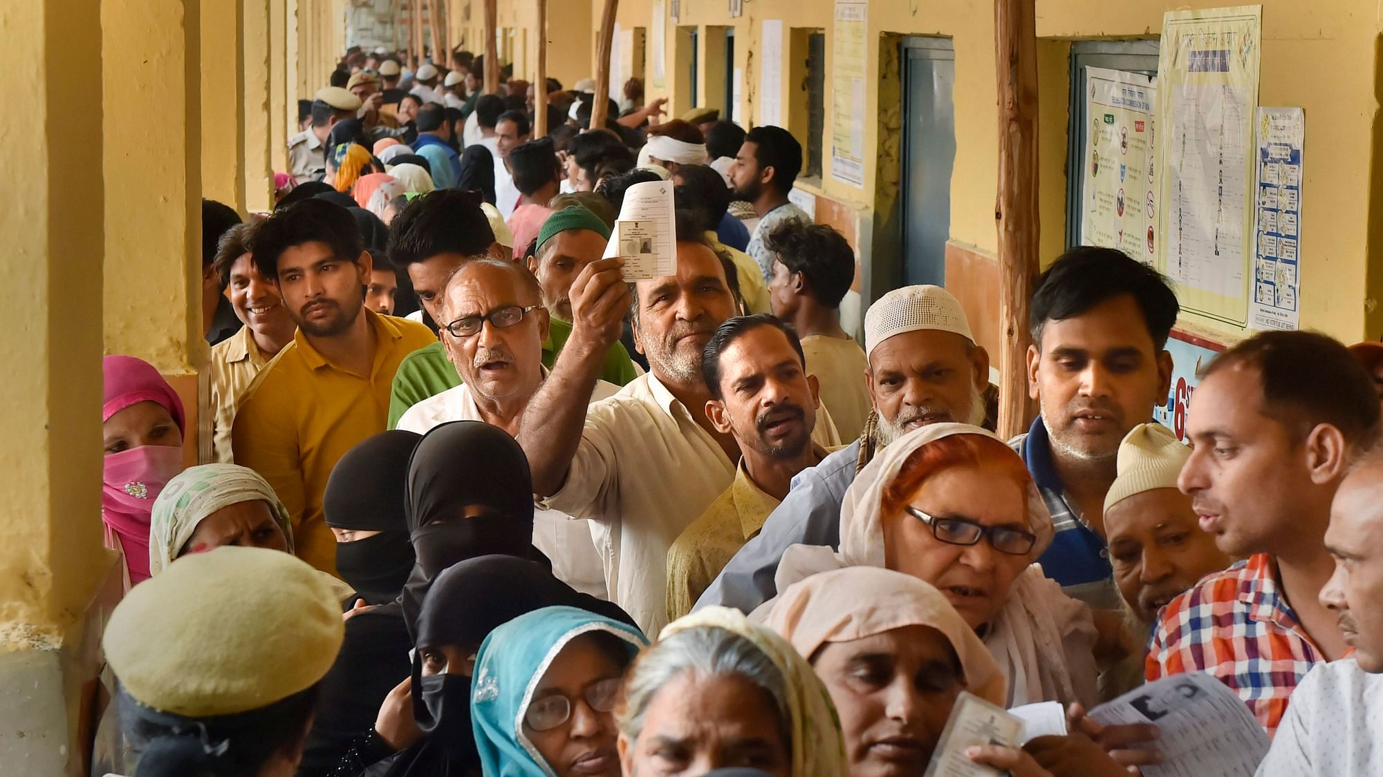 Voters in Delhi waiting in queues to cast their votes.
