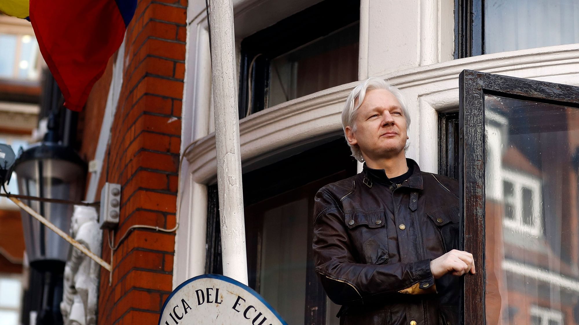  WikiLeaks founder Julian Assange looks out from the balcony while claiming political asylum at the Ecuadorian embassy in London.&nbsp;
