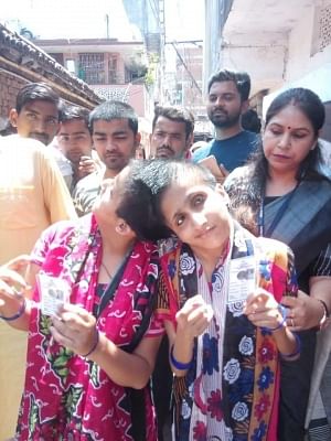 Patna: Conjoined sisters Sabah and Farah arrive to cast their votes as separate individuals in Patna, on May 19, 2019. (Photo: IANS)