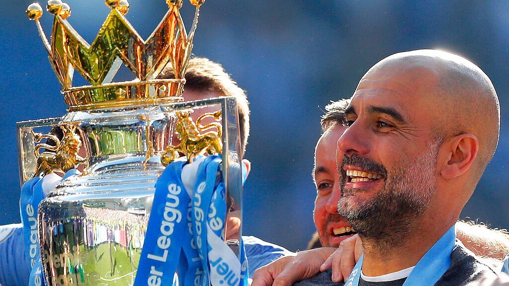 Manchester City Manager Pep Guardiola with the premier league trophy.