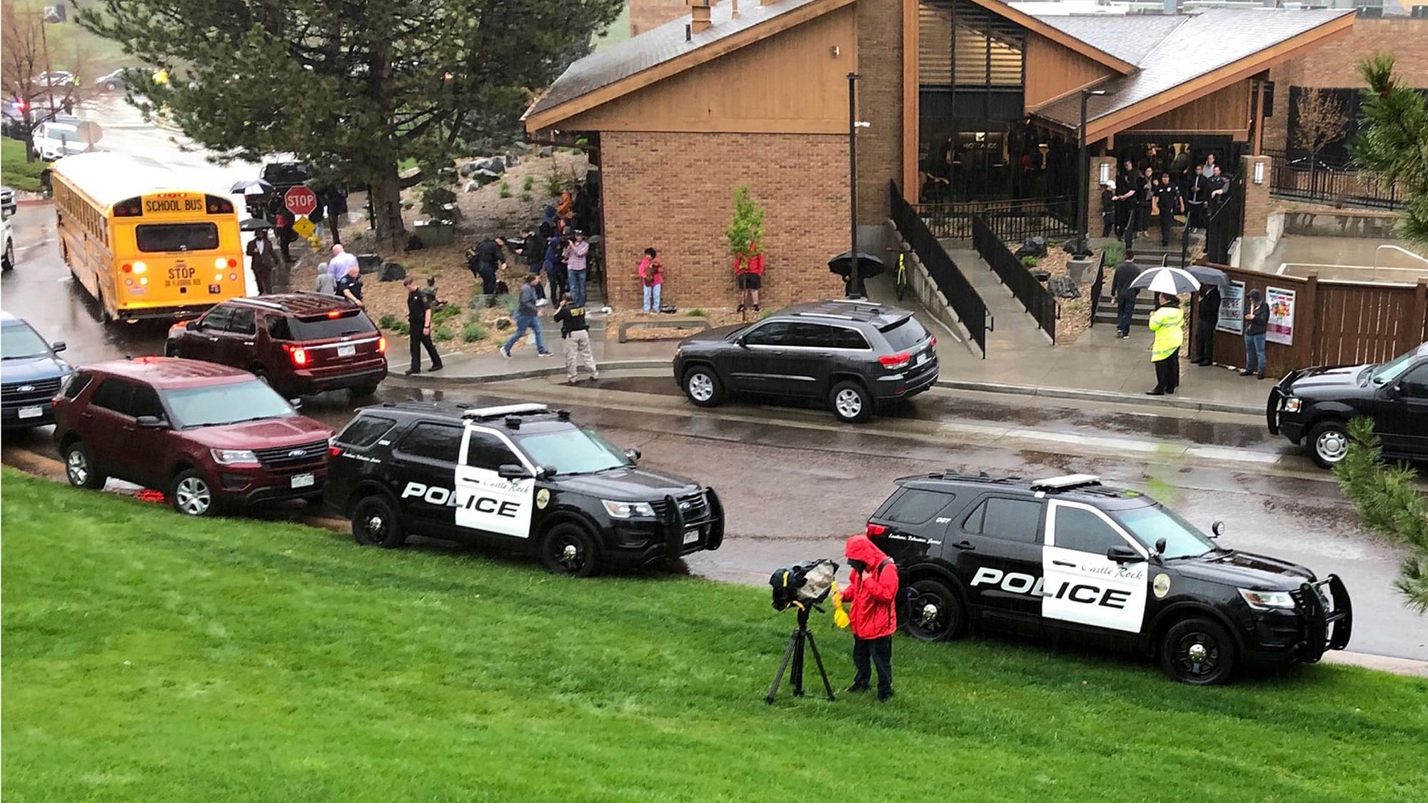 Police and others are seen outside STEM School Highlands Ranch, a charter middle school in the Denver suburb of Highlands Ranch, Colo., after a shooting Tuesday, 7 May, 2019.