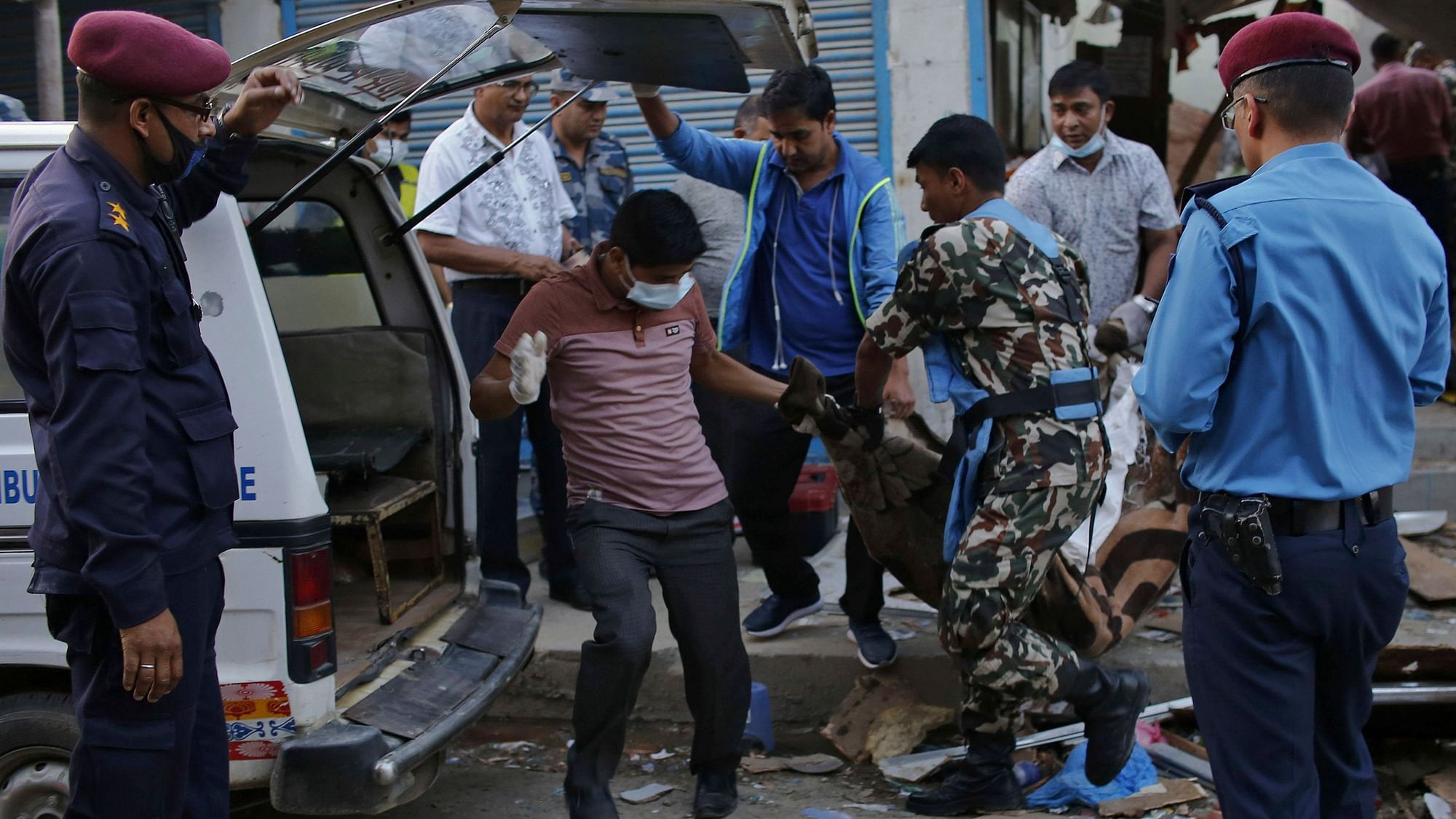 The body of a victim is removed from the site of an explosion in Kathmandu, Nepal.