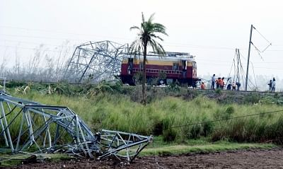 Puri: Technicians from Indian Railways working to fix overhead electrical wires which got by  Cyclone