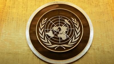 Plaque bearing the United Nations logo above the podium of the General Assembly Hall.