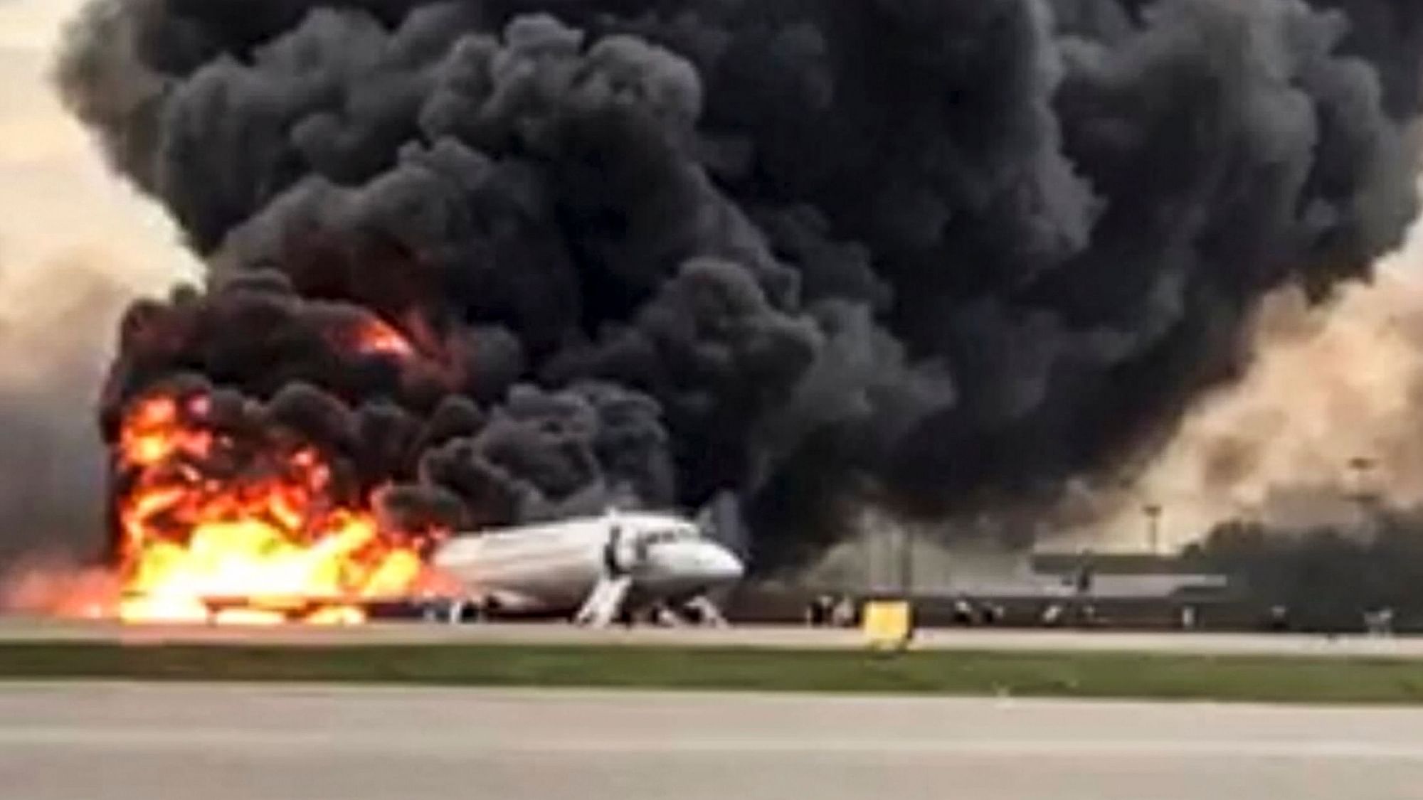 The image shows the Sukhoi SSJ100 aircraft of Aeroflot Airlines on fire.