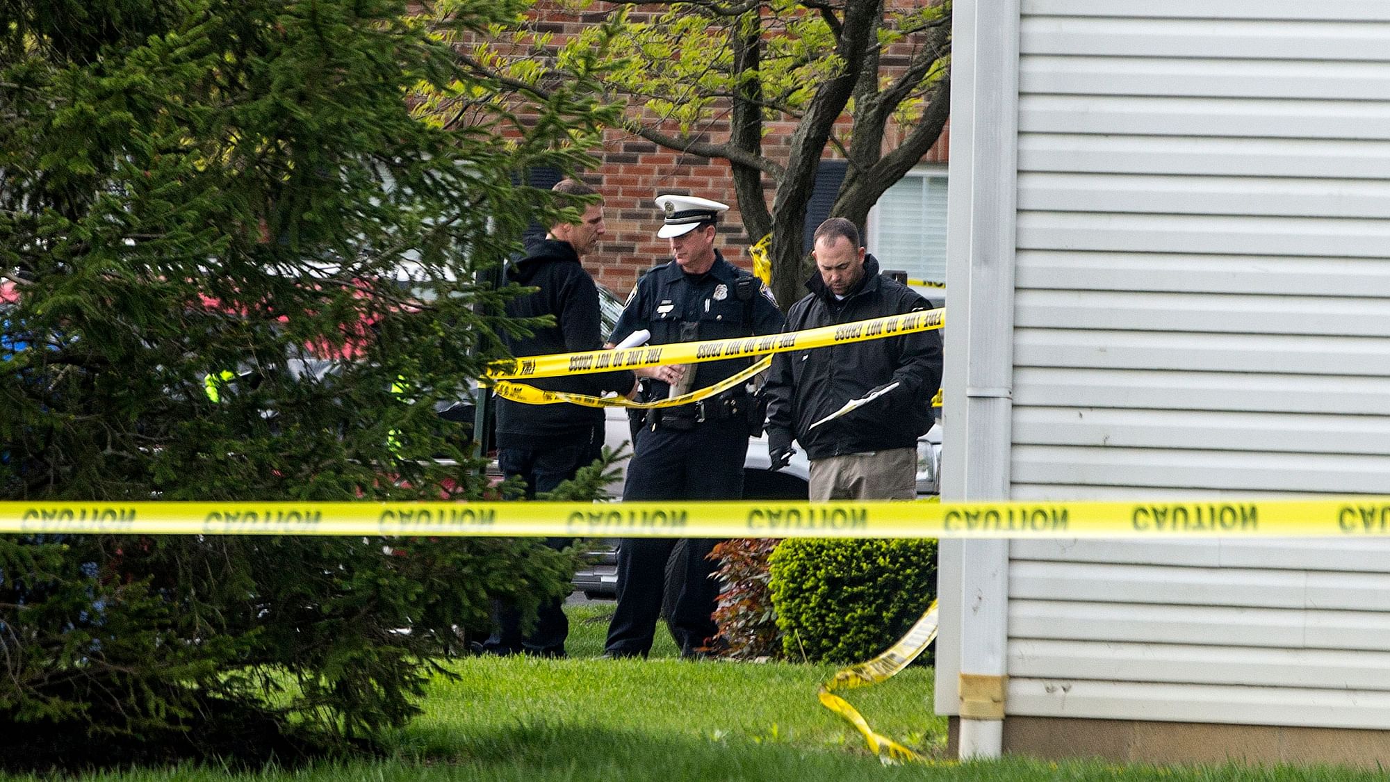 Police work the scene where multiple people were found dead Sunday night, at the Lakefront at West Chester apartment complex in West Chester Township.