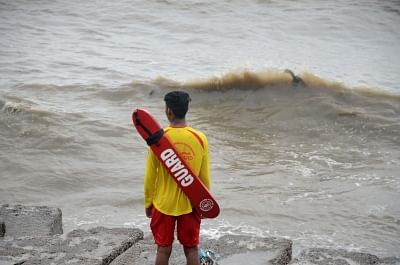 Mumbai: A life guard on duty at a sea beach in Mumbai on June 13, 2019. Life guards on beaches across the city have been asked to ensure that nobody ventures into the sea, in the wake of Cyclone Vayu. (Photo: IANS)